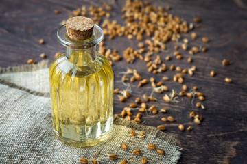 Bottle with wheat germ oil on wooden background