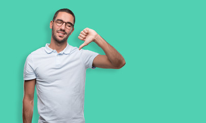 Concerned young man doing a loser gesture