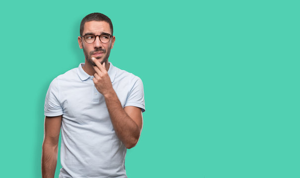 Confident young man with a gesture of doubt