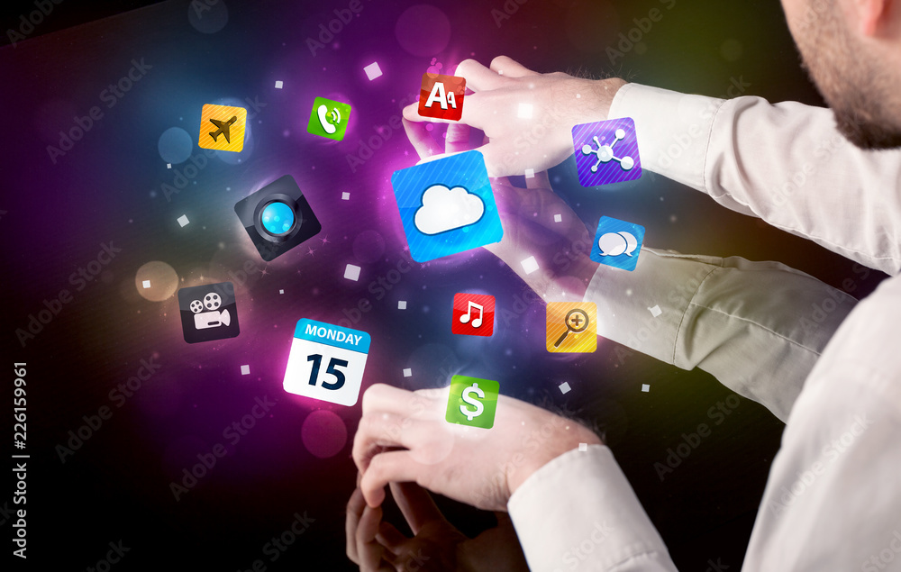 Poster Male hands touching interactive table with colorful application icons on it 