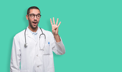 Confident young doctor with a gesture of number four