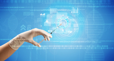 Female doctor hand holding syringe with blue background and charts