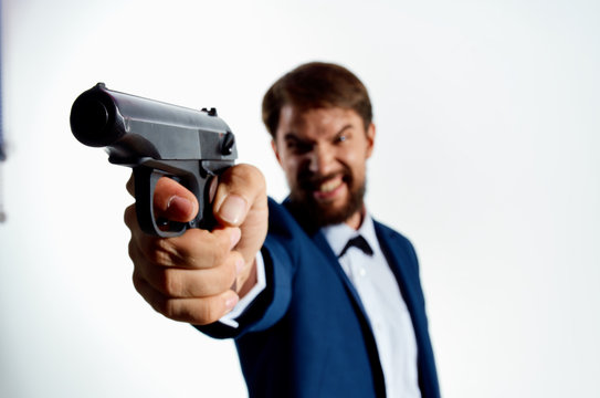 angry dangerous man with a beard holding a gun