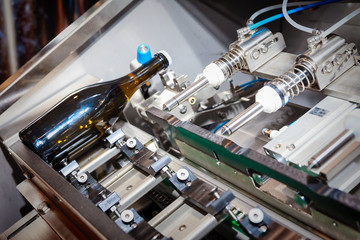 The automatic transfer line of pouring of wine in bottles, demonstration of work