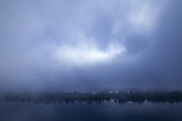 Obraz na płótnie Canvas Fog on the river, ominous evening, background