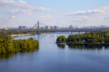 Cityscape on the Dnieper River, Kiev city, Moscow bridge, sailboats, regatta