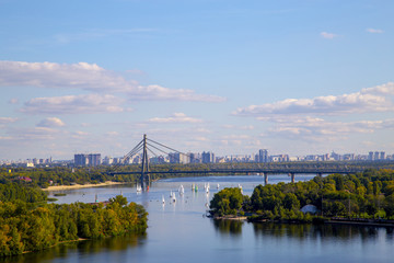 Cityscape on the Dnieper River, Kiev city, Moscow bridge, sailboats, regatta