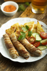 Grilled sausages wrapped with bacon