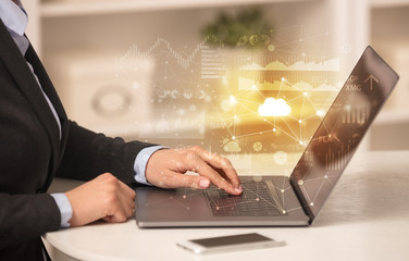 Business woman in homey environment using laptop with cloud technology concept
