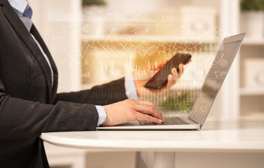 Business woman in homey environment using laptop with global financial report concept
