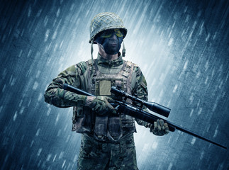Armed soldier standing in rainy weather concept