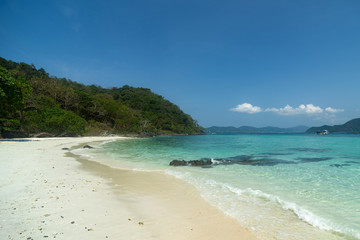 Fototapeta na wymiar A beach with golden sand. Ships in the turquoise sea. Samui island, Thailand