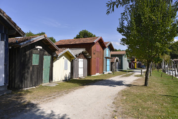 Wooden houses at ostreicole harbor of Biganos, commune is a located on the shore of Arcachon Bay, in the Gironde department in southwestern France. - obrazy, fototapety, plakaty