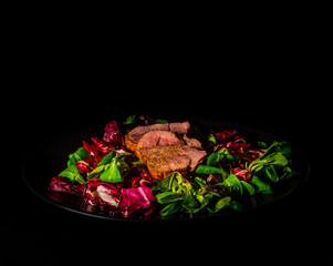 Pork loin chops with salad. Healthy colorful meal. Dark mood photography.