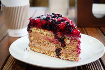 slice of nut cake with berries on a table in a coffee shop