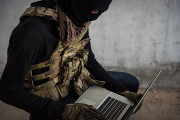 Terrorist man cyber hacker hacking internet to access steal information - obrazy, fototapety, plakaty