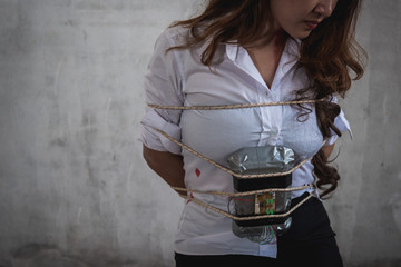 Young woman violence hurting use rope bundle with time bomb