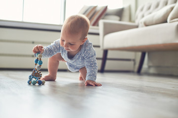 little baby boy crawling on floor at home