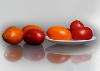 Red and yellow ripe tomatoes lying on the table