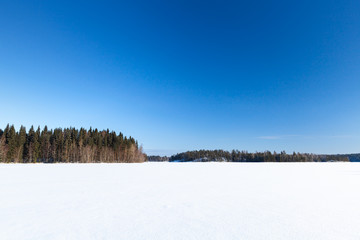 Frozen lake under deep blue sky