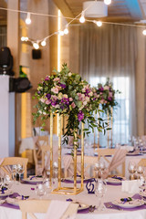 It is a lot of beautiful flowers on a high metal support