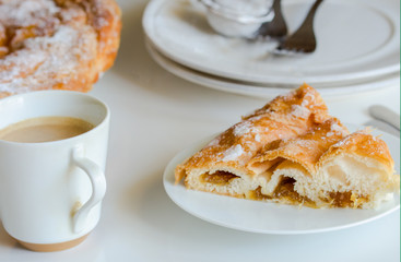 Piece of Ensaimada, coil-shaped flaky pastry from Mallorca, Balearic Islands. This is one of popular pastries in Spain eating at breakfast, snack time and dessert