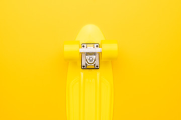 bright yellow mini cruiser board on yellow background