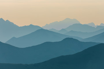 Obraz premium A beautiful, colorful, abstract mountain scenery in sunrise. Minimalist landscape of mountains in morning in blue tones. Tatra mounains in Slovakia, Europe.