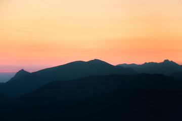 A beautiful, colorful, abstract mountain scenery in sunrise. Minimalist landscape of mountains in morning in blue tones. Tatra mounains in Slovakia, Europe.