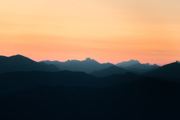 Obraz premium A beautiful, colorful, abstract mountain scenery in sunrise. Minimalist landscape of mountains in morning in blue tones. Tatra mounains in Slovakia, Europe.