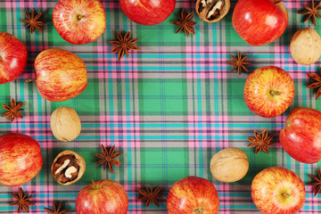 A background with autumn mood formed with apples with free space for text in the center