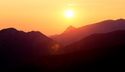 A beautiful, colorful sunrise sceney in mountains in purlpe tone. Abstract, minimalist landscape in Tatra mountains. Color gradients. Tatra mountains in Slovakia, Europe. © dachux21