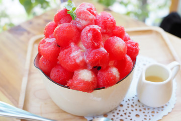 Fresh red watermelon bingsu on wooden table