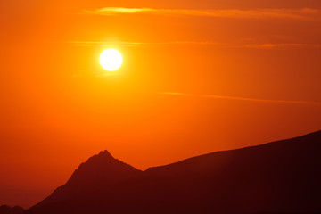 A beautiful minimalist landscape during the sunrise over mountains in warm tones. Abstract, colorful scenery of mountains in morning. Tatra mountains in Slovakia, Europe.