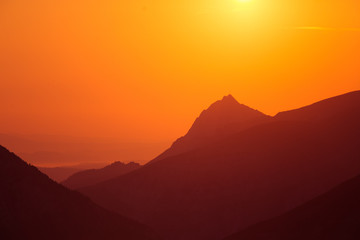 A beautiful minimalist landscape during the sunrise over mountains in warm tones. Abstract, colorful scenery of mountains in morning. Tatra mountains in Slovakia, Europe.