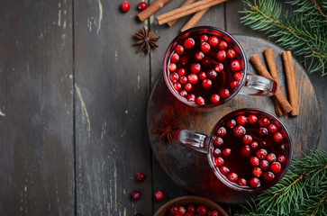 Cranberry Drink on Wooden Background with Fir Branches, Spices and Fresh Berries