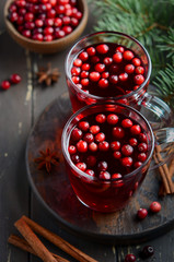 Cranberry Drink on Wooden Background with Fir Branches, Spices and Fresh Berries
