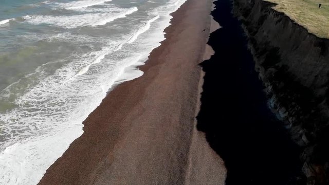 Drone flying along cliffs and sea at Weybourne near Sheringham uk