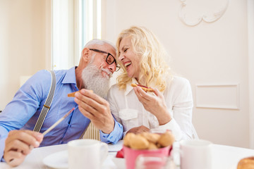 Senior couple having breakfast at home