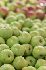 Green apples in a box in the store. green apples in boxes on market shelves. grocery shopping concept. healthy food. vertical photo