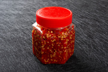 bottle of chilli sauce on dark
