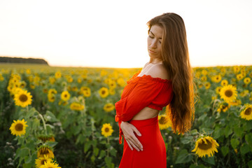 Beauty joyful girl in sunflower field