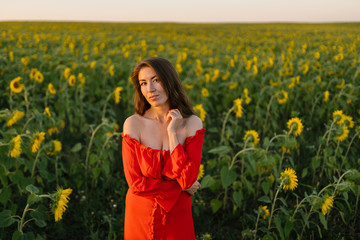 Beauty joyful girl in sunflower field