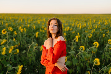Beauty joyful girl in sunflower field
