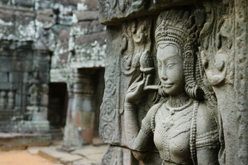 Fototapeta na wymiar CarveCarved wall bas-relief of Angkor Wat complex temple, archaeologic park ,Cambodia