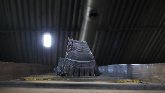 old tyre piece transported by conveyor for future recycling