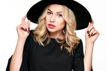 Sensual Halloween Witch Studio Portrait. Attractive young woman dressed in witch halloween costume isolated over white background.