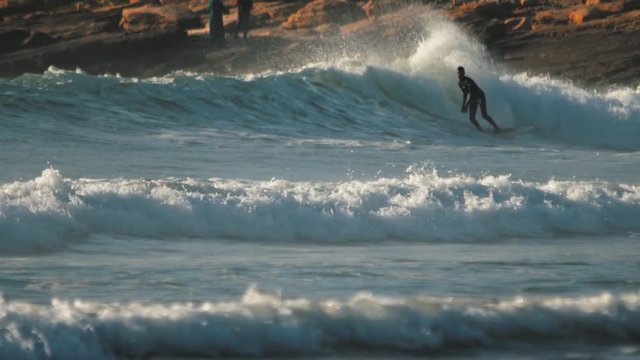 Agadir - Surfer on Blue Ocean Wave falls. Morocco. 4K