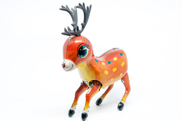 Antique tin toy reindeer isolated on white background