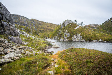 A beautiful landscape of a mountain lake in Folgefonna National Park in Norway. Overcast autumn day in mountains. Autumn scenery of lake.